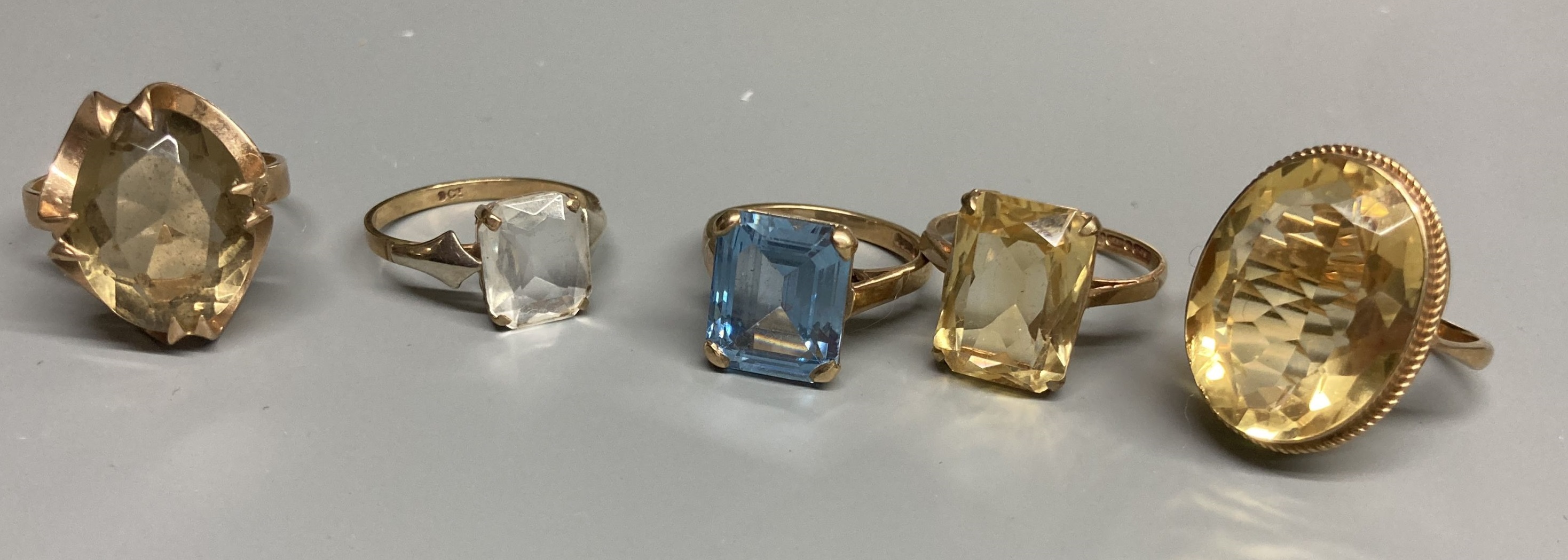 Four assorted modern 9ct gold and gem set rings, including citrine and smoky quartz and a similar 9ct ring